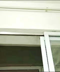 Built Tough Heavy Duty Sliding Barn Door Hardware Track Kit installed on wall, silver track with 8-wheel hanger system