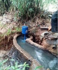 Micro Hydro Turbine Generator 3KW for rivers and creeks installed in a natural stream, blue die cast aluminum case, 220V single phase.