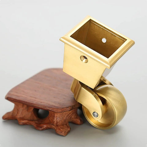 Top Shelf Solid Brass Casters delivering three sixty degree swivel grace for any couch sofa or desk antique style gold cup roller close-up.