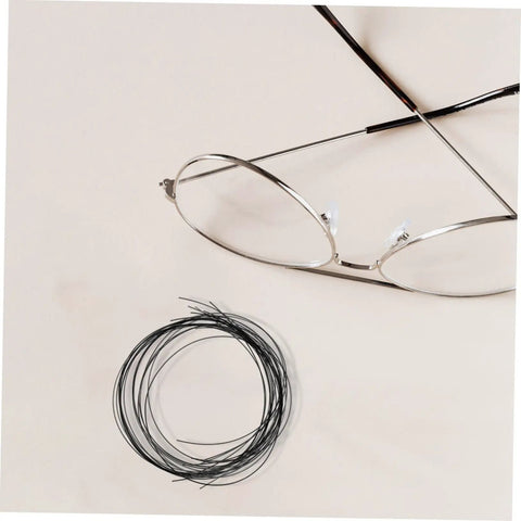 Replaceable Eyeglass Repair Thread for Quick Eyewear Adjustments, Lightweight Fixing String Kit next to metal frame glasses.