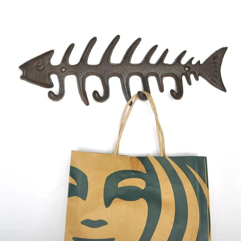 Handcrafted Cast Iron Fish Bone Wall Hooks Vintage Coastal Coat Rack And Entryway Key Holder With Mounting Screws, 13x4 inches, holding a bag.