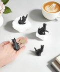 Vintage Cat Drawer Knobs Set Of 4 Black Iron Cabinet Handles displayed with a coin for scale on a tabletop.