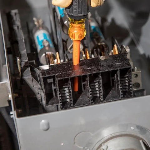 Slim Tip Insulated Screwdriver Set 1000V, 4-Piece in use with orange handle, in tight electrical panel, made in USA.