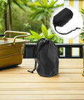 Two Pack Waterproof Rain Gear Storage Bags With Drawstring Pouches on outdoor table, featuring black fabric design