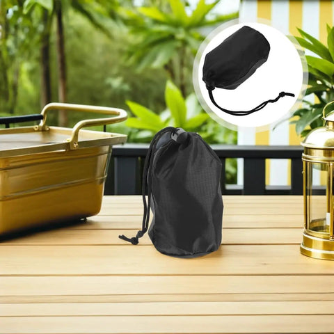 Two Pack Waterproof Rain Gear Storage Bags With Drawstring Pouches on outdoor table, featuring black fabric design