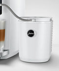 Hella Sleek Chilling Unit Featuring Solid Aluminum Cover And Hygienic Design Keeps Drinks Ice Cold With Quick Setup next to a glass of layered latte.