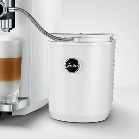 Hella Sleek Chilling Unit Featuring Solid Aluminum Cover And Hygienic Design Keeps Drinks Ice Cold With Quick Setup next to a glass of layered latte.