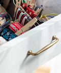 Drawer with Six Pack 5 Inch Center To Center Modern Champagne Bronze Cabinet Pulls With Sleek Tapered Handles and colorful ribbons inside