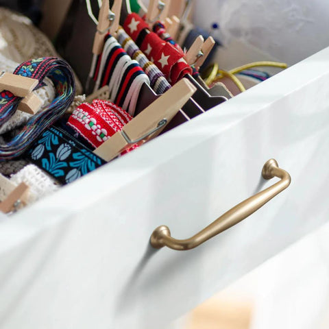 Drawer with Six Pack 5 Inch Center To Center Modern Champagne Bronze Cabinet Pulls With Sleek Tapered Handles and colorful ribbons inside