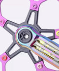 Pink 5 Pack 7075 Aluminum Chainring Bolts for Road and MTB Cranksets, 6.5mm nuts, on black and pink bike crankset