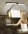 2 In 1 LED Desk Lamp With Clamp, 24W Ultra Bright Table Lamp illuminating piano sheet music while a girl plays