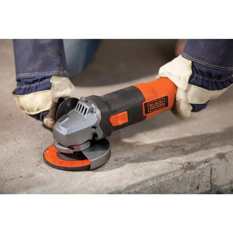 Gloved hands using Beefy 4-1/2 Inch Angle Grinder With 6.5 Amp Motor Heavy Duty Metal Gear Case for surface prep on concrete