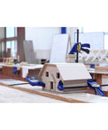 Six Inch Mini Bar Clamp Two Pack With One Hand Quick Release Trigger securing a wooden house model in a workshop.