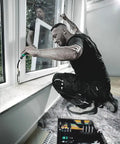 Worker using Pro Grade Window Installation Screwing Tool Set With Ergonomic Handles for precise fastening on window frame.
