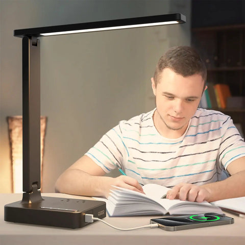 Modern LED Desk Lamp With USB Ports And Type C used by man studying at desk, showing touch control and charging phone