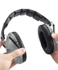34 dB NRR Hearing Protection Ear Muffs For Loud Events And Sensory Use Ultra Slim And Lightweight Design For All Day Comfort Yet Durable High Noise Reduction Earmuffs For Concerts And Everyday Noise Grey. Hands adjusting the padded adjustable headband of slim grey earmuffs.