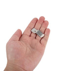 A hand holding one piece of the Glass Clips Quick Mount Hook Bracket Set Heavy Duty Stainless Steel 50 Pieces Elastic Adjustment Precision Polished Surface Metal Fastening Clips For Organizer Shelves Damage Free Mounting Without Nails Or Adhesives.