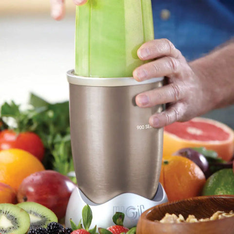 Person using 900W Nutribullet blender surrounded by fruits, showing Milling Blade Replacement For Nutribullet 600W And 900W Blenders.