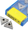 TNMG160404 AK H01 carbide turning inserts (10 pcs) in blue case with yellow label; two inserts outside