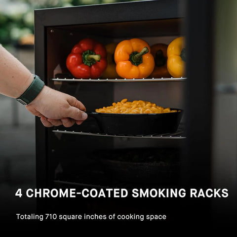 Hand placing dish in Digital Electric Vertical BBQ Smoker With Patented Side Wood Chip Loader And Chrome Racks 710 Square Inches