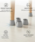 Gray PU Leather Furniture Leg Protectors 8 Pack Scratch Resistant Floor Guards For Hardwood And Tile Silent Glide Chair Table Foot Caps placed under a wooden table leg.