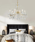 Modern Crystal Chandelier Light Fixture With Six Lights, Raindrop Pendant Crystals In Maria Theresa Brass Finish in bedroom