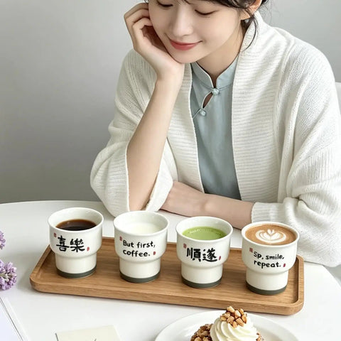 Ceramic demitasse espresso cups set of 2, 3.52 oz handleless mugs on tray with designs, used for coffee, minimalist kitchen display.