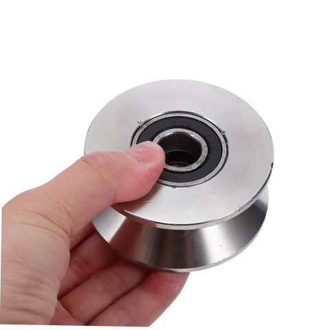 Heavy Duty Stainless Steel Sliding Door Rollers U Groove Caster Wheels with smooth glide track, hand-held close-up view.