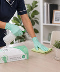 Kickass Sustainable Nitrile Gloves In Vibrant Green, Premium Powder Free And Latex Free Disposable Safety Wear For Restaurant Shifts And Weekend Projects, Hella Grippy 100 Count Large Box, person using gloves to clean a table.