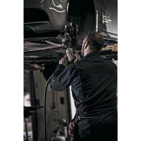 Mechanic using Heavy Duty Half Inch Drive Air Impact Wrench With Up To 1350 Foot-Pounds Of Nut Busting Torque for repair