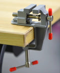 Mini Jeweler Table Clamp For Jewelry Making And Electronics Craft Projects Portable Bench Vise Great For Small Repairs And Model Building Handy Tiny Work Clamp For Crafting Jewelry DIY Projects And Hobbyists, installed on a table.