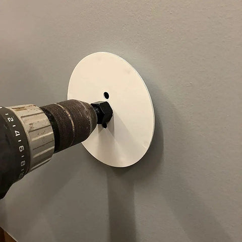 Drill using Drywall Repair Kit With Tapered Hole Saw And Two Plugs For Clean Flat Patches on a wall