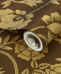Premium Brown Gold Metallic Wallpaper With Block Print And Textured Finish For Modern Home Decor rolled up showcasing floral design