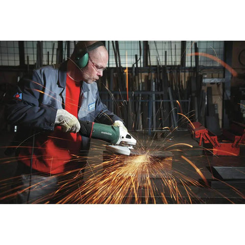 Person using 7 Inch Angle Grinder With 8500 RPM And 15 Amp Motor Locking Slide Switch VibraTech For Reduced Vibration German Engineered Power Tool in workshop.