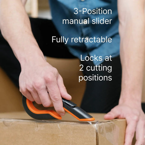 Slice 10400 box cutter with orange/black handle; 3-position slider used to cut a cardboard box.