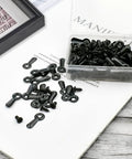 Black metal picture frame hardware set with 160 screws, turn buttons, and hanging hangers in a clear plastic box