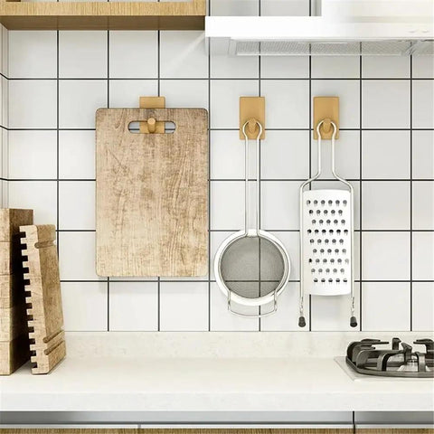 Modern Wall Mounted Coat Rack With Smooth Beige Finish Sleek Space Saving Design For Entryways holding kitchen tools on a tiled wall.