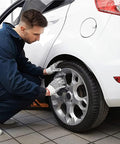 Mechanic cleaning a car tire with Fast 505 Cleaner And Degreaser 128 Ounces Heavy Duty Industrial Strength Degreaser For Grease Oil And Grime