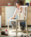 Person using Fast Drying Boiled Linseed Oil For Wood Restoration And Protection Pro Grade Formula on a wooden chair