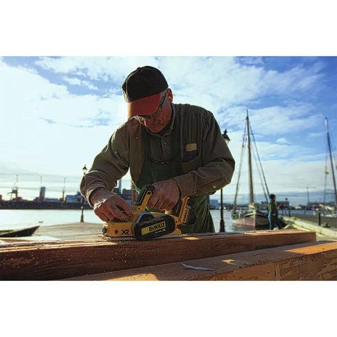 Pro Grade 20V Max Xr Brushless Cordless Planer Drops Dead Serious Amps For Zero Drag Wood Planing And Cabinet Refinishing Job Site Ready Tool Only Renewed in use on wood at a dock.