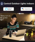 Woman controlling Smart LED Flood Lights Outdoor 200W Equivalent RGB Plus CW Color Changing Spotlight Kit With App Control indoors