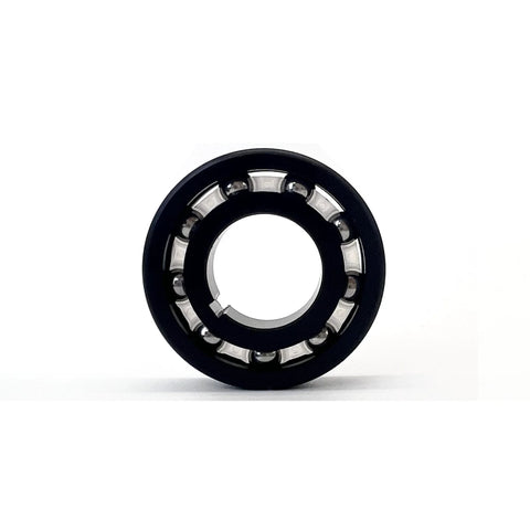 Front view of DUODUO pool cleaner main turbine bearing, black outer ring with silver steel balls.