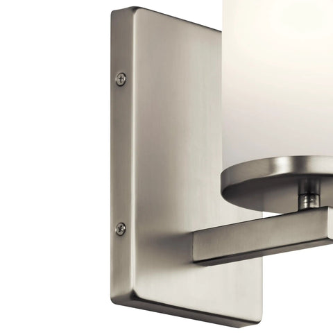 Close-up of Crosby 9.25 Inch Wall Sconce in Brushed Nickel, highlighting brushed metal finish and opal glass shade.