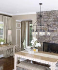 Dining area with stone fireplace, modern ceiling light, Topsail Three Light Inverted Pendant in polished chrome, sleek design