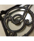 Hella Sturdy Rock Solid Cast Iron Wall Mounted Corner Support Brackets With A Killer Vintage Floral Design detail in dark iron, highlighting decorative swirls.