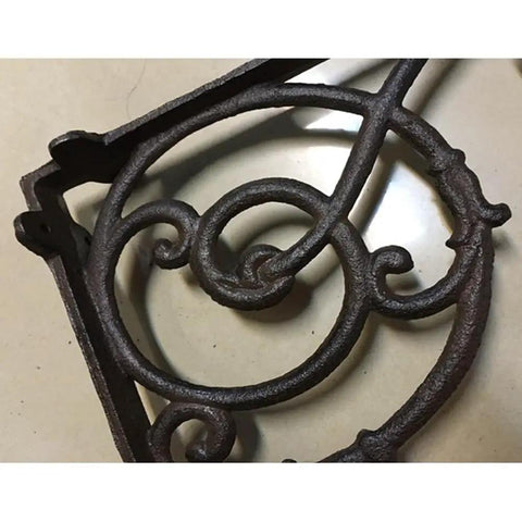 Hella Sturdy Rock Solid Cast Iron Wall Mounted Corner Support Brackets With A Killer Vintage Floral Design detail in dark iron, highlighting decorative swirls.