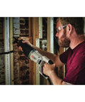 Man using Heavy Duty 7.5 Amp Variable Speed Corded Reciprocating Saw for cutting wood and metal at job site.