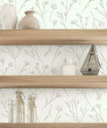 Brown and white twigs peel and stick wallpaper roll for easy wall makeover behind wooden shelves with decor items