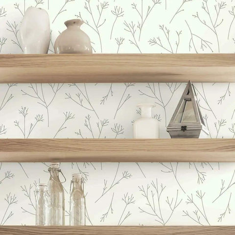 Brown and white twigs peel and stick wallpaper roll for easy wall makeover behind wooden shelves with decor items