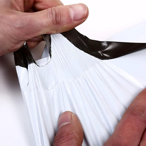 Hands stretching a White Plastic Mailing Bags Pack Heavy Duty Self Seal Envelopes Lightweight Yet Thick And Durable Weatherproof